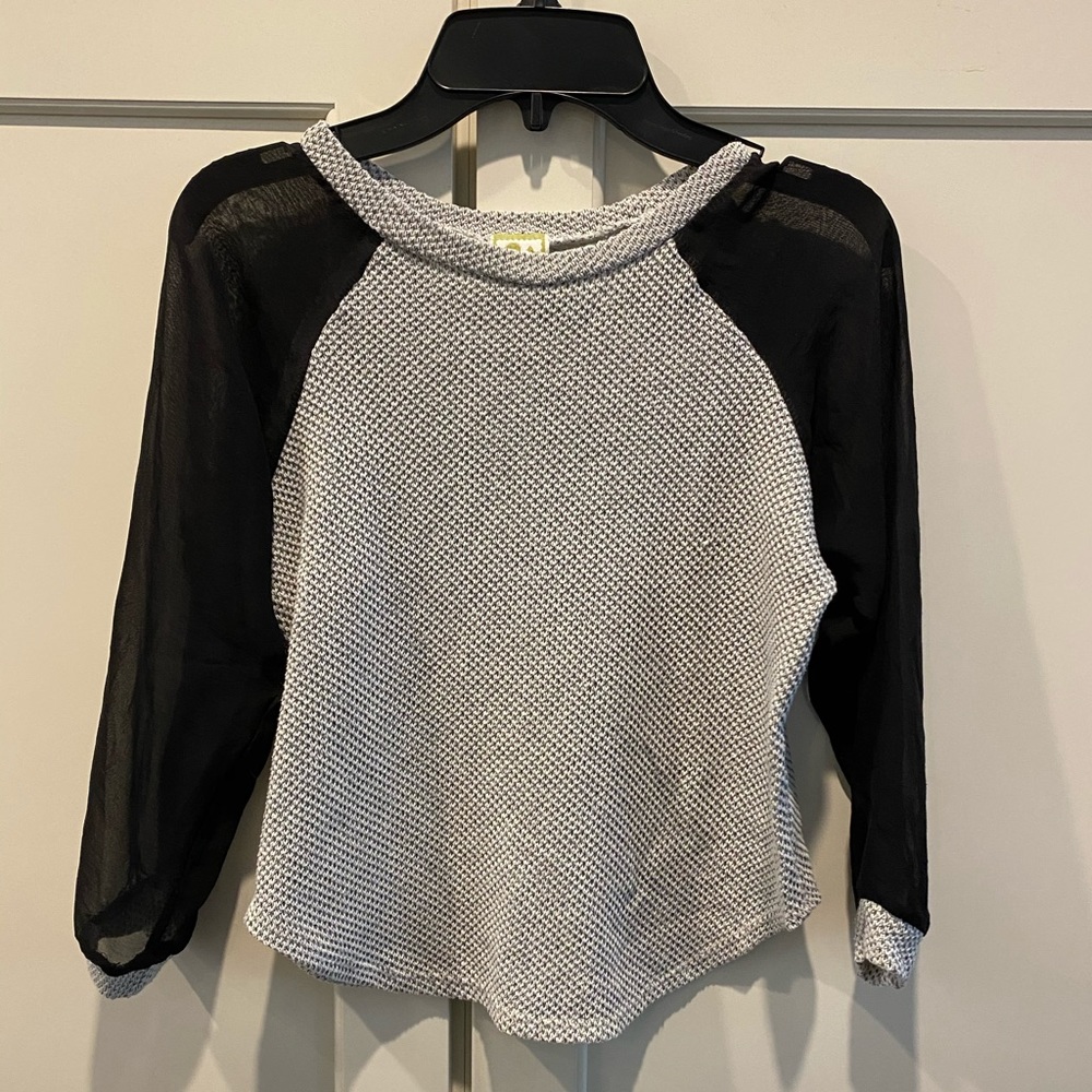 Girls gray top with black mesh sleeves.